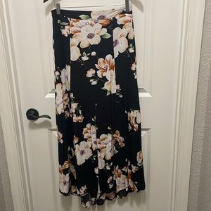 LLove black & floral maxi skirt size M semi high/low w/ slit at bottom of skirt